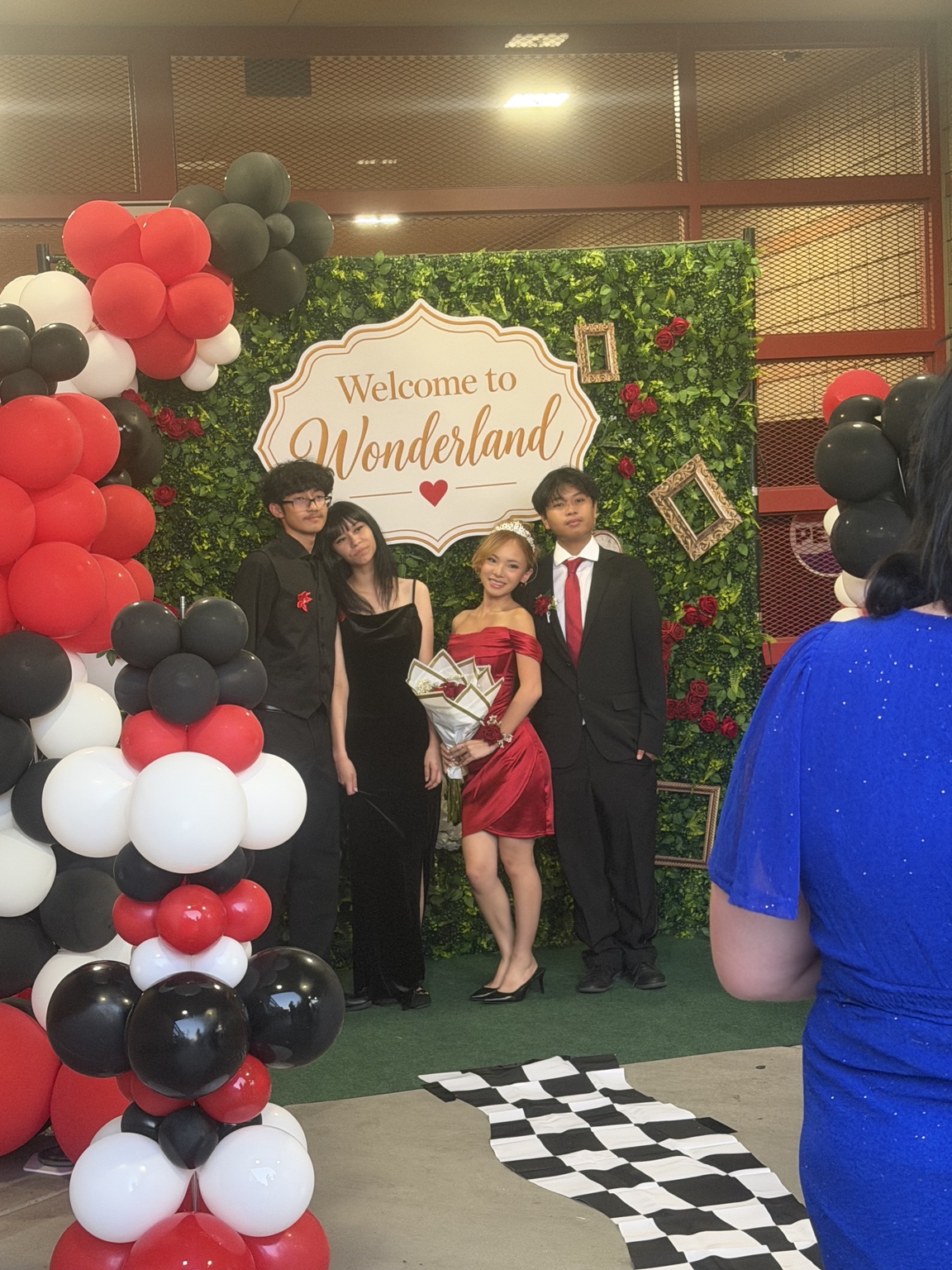 Guests enjoying the Wonderland backdrop at Del Sol Academy