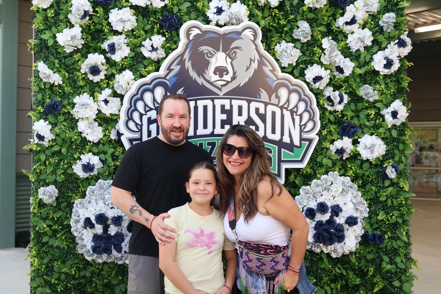 Family portrait in front of the Gunderson Grizzlies backdrop